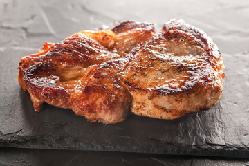 fried pork steak on a black stone