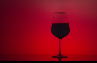Wine glass on red background