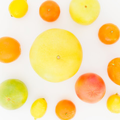 Citrus fruits - lemon, orange, grapefruit, sweetie and pomelo on white background. Flat lay, top view. Fruit's background