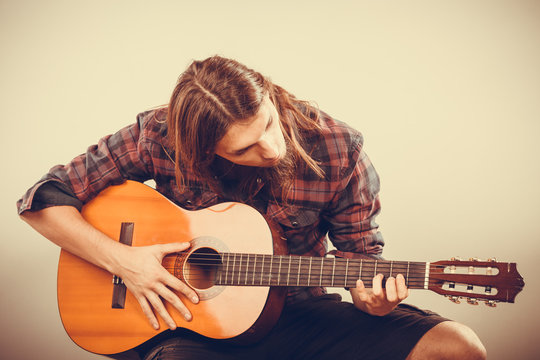 Guitarist is playing the guitar.
