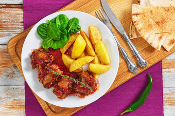oxtail stew with fried potato and spinach salad