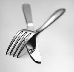 knife and fork on grey background