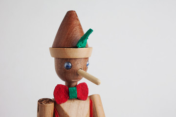 Wooden Pinocchio doll isolated on white background.