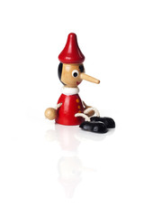 Wooden Pinocchio doll isolated on white background.