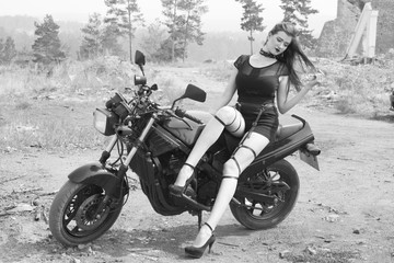 Fototapeta na wymiar Beautiful slender girl and a sport bike.