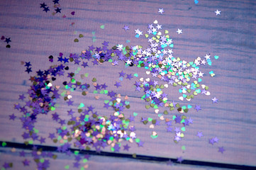 Colorful Confetti in the shape of a heart in front of purple Background
