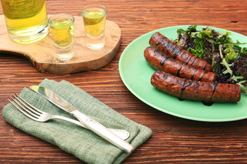 Grilled sausages with greens