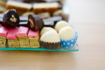 Colorful and delicious home made small cakes arranged on glass plate