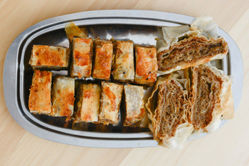 Traditional serbian cake baklava arranged on metal plate.