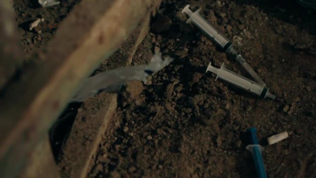 Syringes from drug addicts in the mud