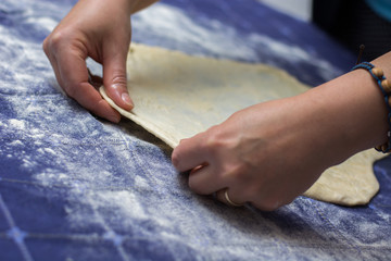 Creating homemade Phyllo or strudel dough on a home table cloth