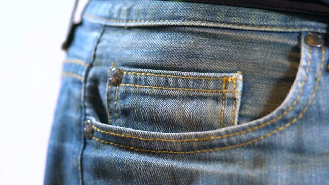 Putting Australian money into jeans pocket.