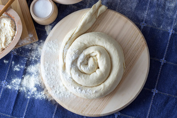 Cheese pie  on the wooden plate ready for baking