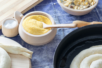 Corn flour in the wooden bowl with wooden spoon.