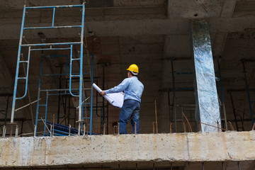 Construction concepts, Engineer and Architect working at Construction Site with blueprint