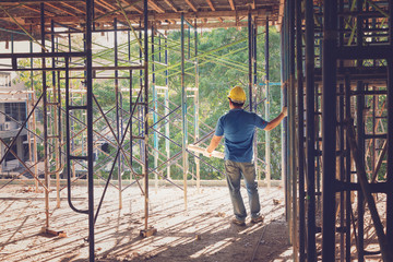 Construction concepts, Engineer and Architect working at Construction Site with blueprint, Vintage Effect