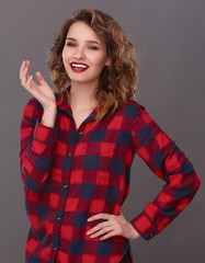 Young woman standing, isolated on gray background