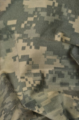 Universal camouflage pattern, army combat uniform digital camo, USA military ACU macro closeup rip-stop fabric texture background crumpled wrinkled foliage green desert sand tan NYCO cotton vertical © Brilt