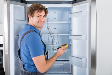 Male Technician Checking Refrigerator