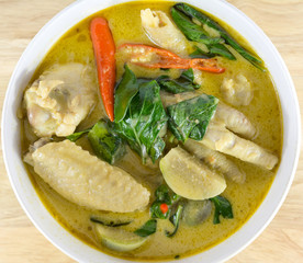 green curry chicken on wood table. Thai cuisine