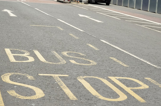 Bus lane sign on road, London, UK.