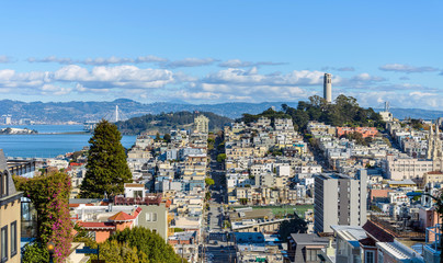 Telegraph Hill - A panoramic view of neighborhoods of Telegraph Hill, Coit Tower and San Francisco Bay, looking from top of Russian Hill, San Francisco, California, USA. 