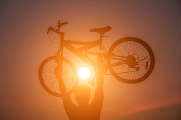 Fototapeta na wymiar Man lifting a bicycle 