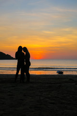 Fototapeta premium Two Models Checking Their Phone on an Island Beach