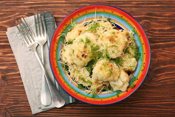 Fried cauliflower with cheese and greens