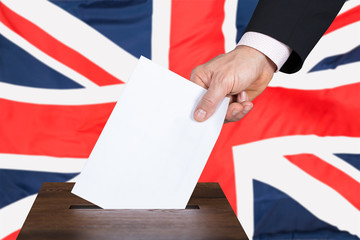 Businessperson Putting Vote Into Ballot Box