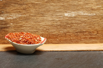 The rice berry put in the small porcelain bowl represent the rice and raw food material and thai rice concept related idea.