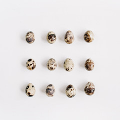 Quail eggs on white background. Flat lay, top view. Easter concept.