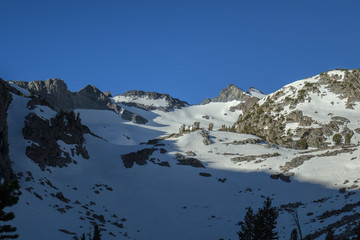 Sierra Sunlight - Sunlight across a snowy Sierra Nevada mountain face on the pacific crest trail.