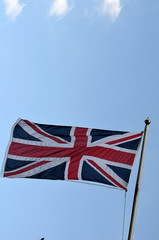 Flag of United Kingdom is Flying in sky.