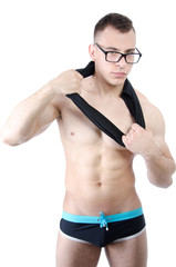 Muscular man posing. Sexy guy in glasses posing in the studio.