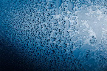 Wet metal background,in blue tone.