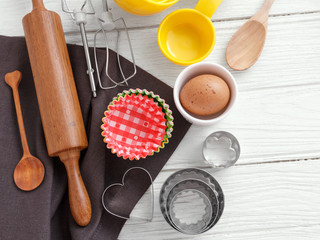 Baking utensils on white wood background