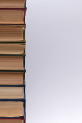 Stack of old thick books on a white background