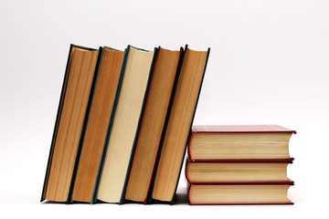 Stack of old thick books on a white background
