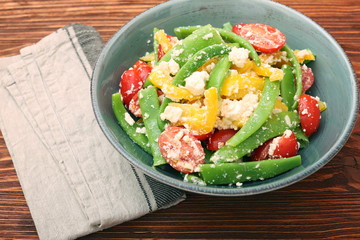 Snow pea salad with feta, tomato and pepper