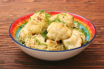 Fried cauliflower with cheese and greens