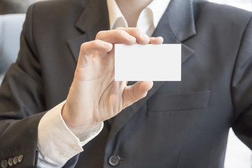 Blank business card in hand businessman closeup