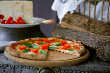 Neapolitan pizza with mozzarella, cherry tomato and fresh basil	