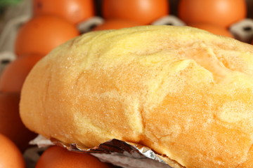 The bread with sugar and butter spread on the top put on chicken egg represent the egg and food concept related idea.
