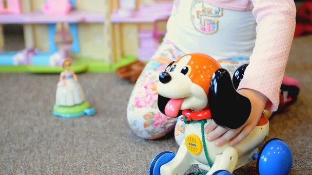 little girl plays a toy kindergarten room