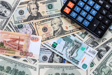 Dollar and ruble bils and black calculator.