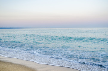 Fototapeta na wymiar summer landscape, the sand on the beach, blue sea with waves.