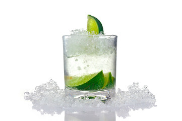 Cocktail with lime and ice in a glass on a white background for isolation