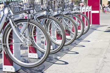 Five rental bicycles parked on a italian street - image with copy space