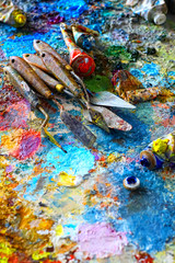 Fototapeta na wymiar Paints and brushes,lying on painted background